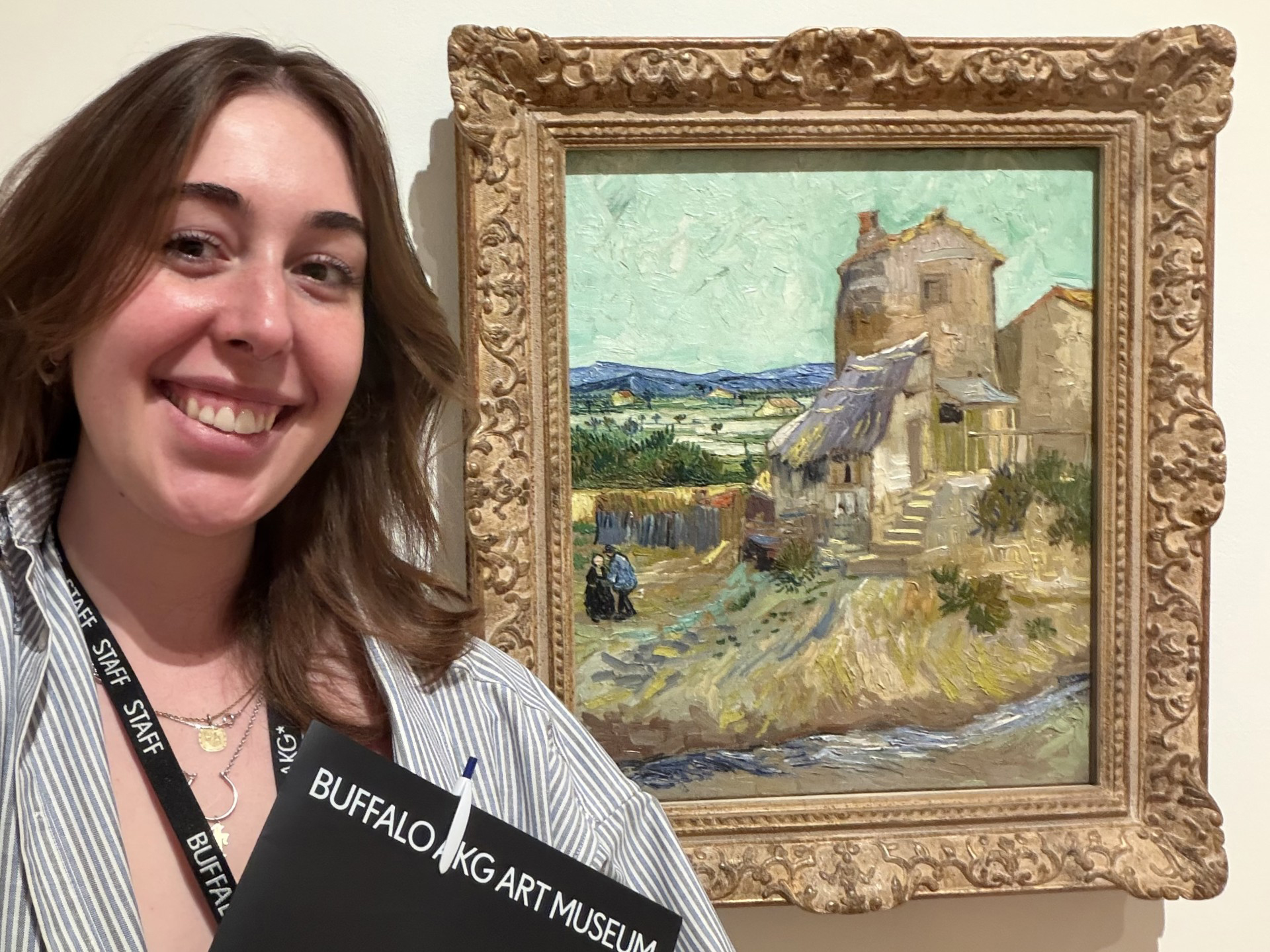 Taylor Lannon '23 at the Buffalo AKG Museum on their first day as a Visitor Services Attendant in front of a painting by Vincent van Gogh.